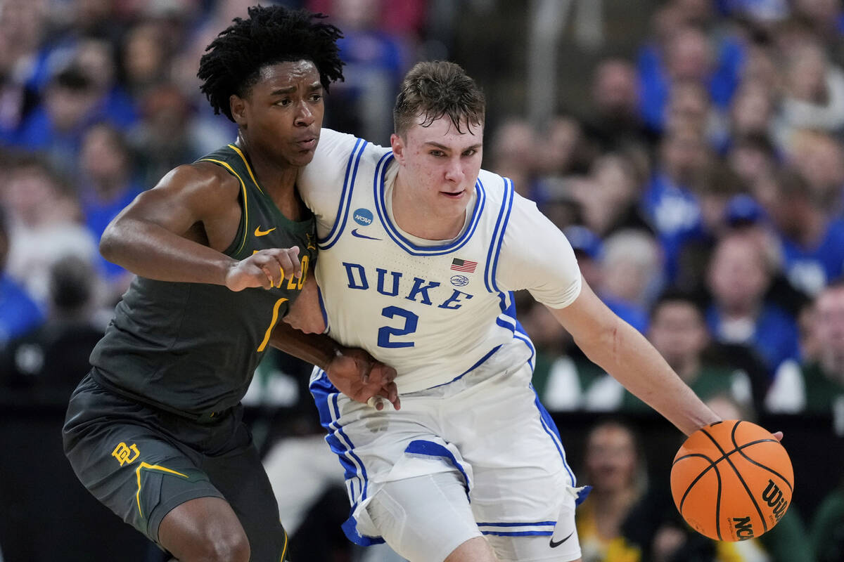 Duke forward Cooper Flagg (2) drives past Baylor guard Robert Wright III (1) during the second ...