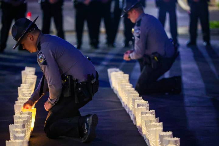 Troopers light candles during a vigil hosted by the Nevada Highway Patrol to honor traffic acci ...