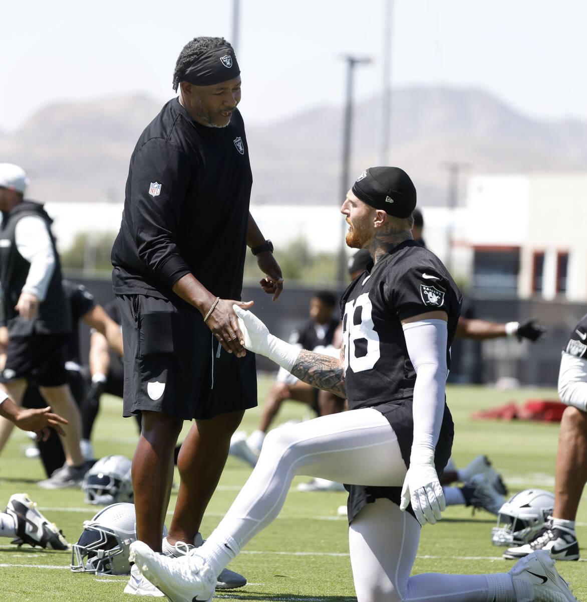 Raiders defensive coordinator Patrick Graham greets defensive end Maxx Crosby (98) during organ ...