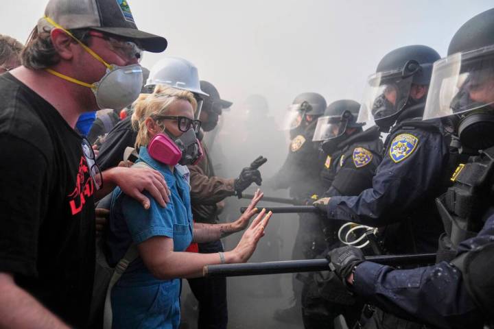 Protesters confront police on the 101 Freeway near the Metropolitan Detention Center of downtow ...
