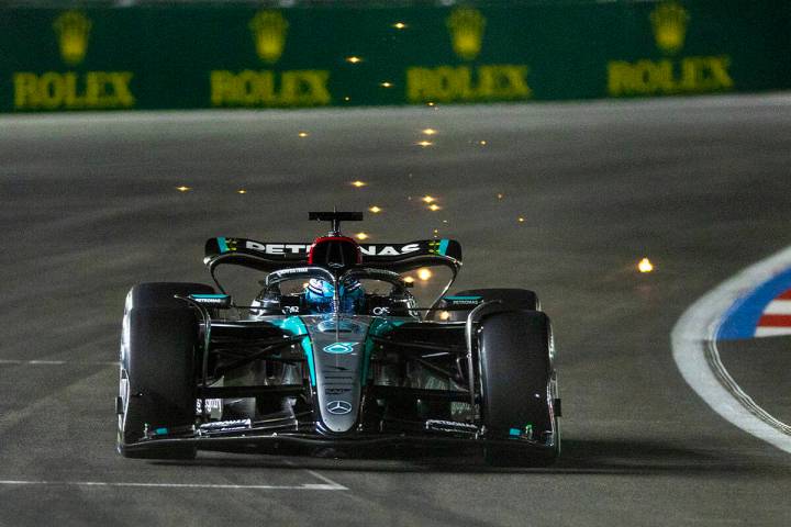 Mercedes driver George Russell sends some sparks flying while in the final turn on the track du ...