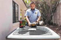 Service technician with Sahara Air Conditioning & Heating Jeremy Rojas repairs an air condition ...