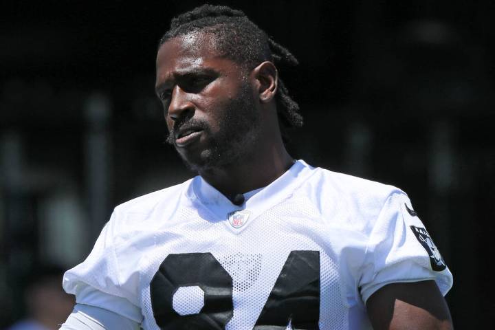 Raiders wide receiver Antonio Brown (84) stretches on the sideline during mandatory minicamp at ...