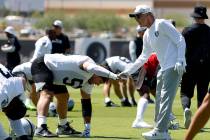 Raiders center Jackson Powers-Johnson (58) shakes hands with head coach Pete Carroll as he stre ...