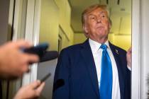 President Donald Trump speaks with reporters while flying aboard Air Force One en route from Ca ...